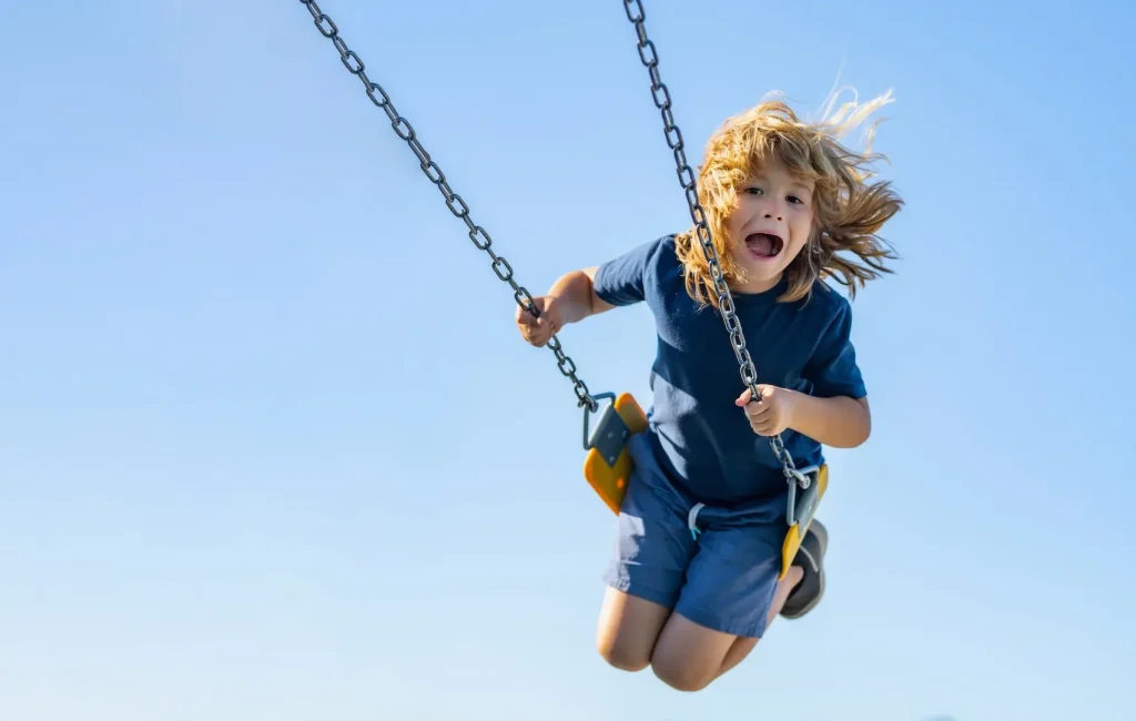 Child playing on swingset in the Four Corners